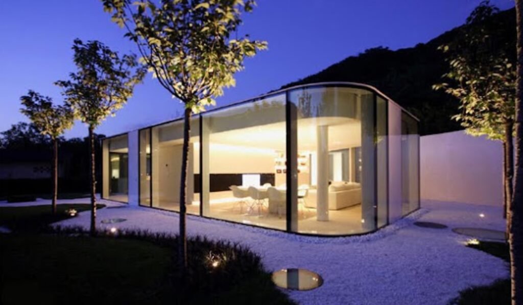 Contemporary glassed house lit at night